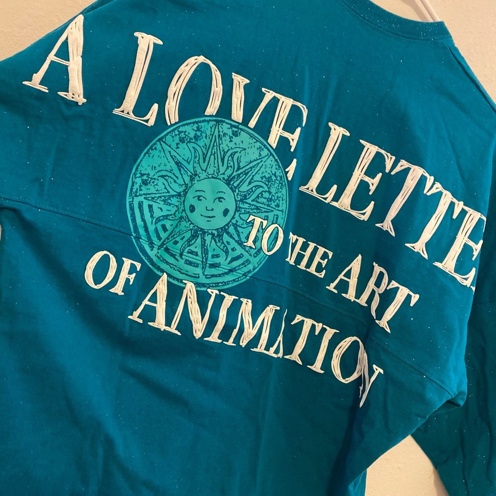 Disney Cirque du Soleil Glittery Teal Long Sleeve Spirit Jersey - Picture 5 of 5